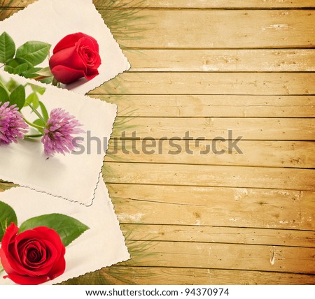 Old photo with flowers on a wooden background