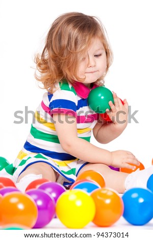 Beautiful little girl count colorful balls
