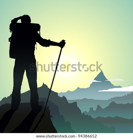Hiking man with rucksack in mountain in the morning