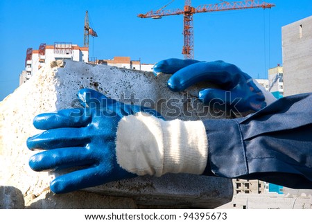 man hands closeup with brick at building background
