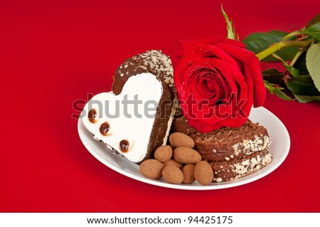 Pink rose and cake on the red background