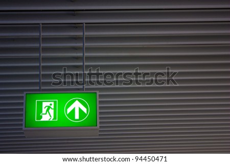 Emergency exit sign in modern offices inside an industrial plant
