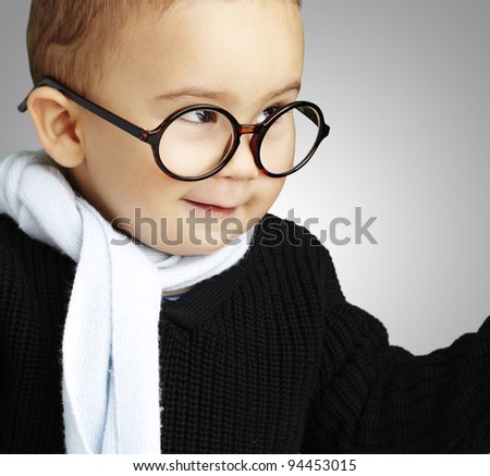 portrait of adorable kid gesturing doubt against a grey background