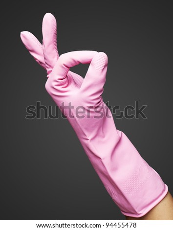 pink rubber gloves gesturing rabbit against a grey background