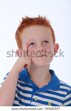Red head boy wearing blue striped shirt with thinking expression on face