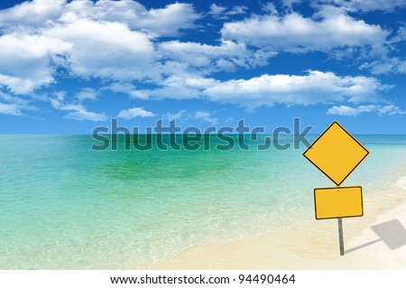 Beautiful remote beach with yellow sign