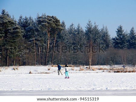 People skating on ice on a frozen lake in the netherlands