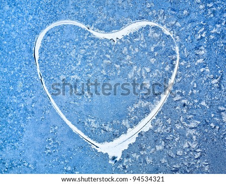 Snowflakes at a window in the form of heart