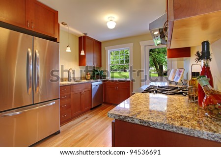 New cherry kitchen with grey granite and stainless steal appliances.