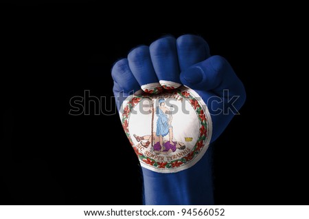 Low key picture of a fist painted in colors of american state flag of virginia
