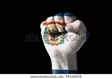 Low key picture of a fist painted in colors of american state flag of west virginia