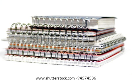 Multi colored Spiral notepads on white background background