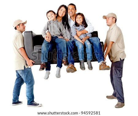 Men carrying a sofa with a family moving house - isolated over a white background