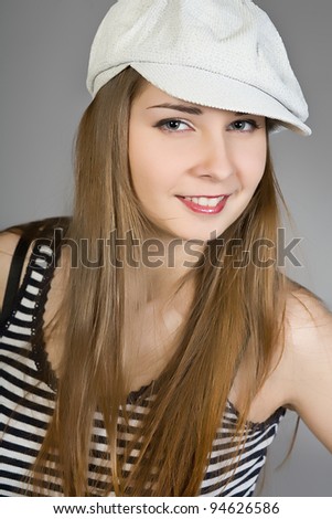 attractive brunette in a white cap and a striped vest