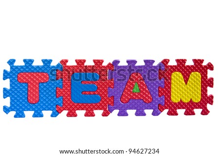 The word "Team" written with alphabet puzzle letters isolated on white background