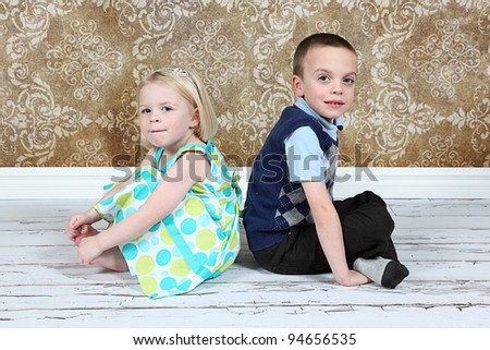 Adorable little brother and Sister on studio background