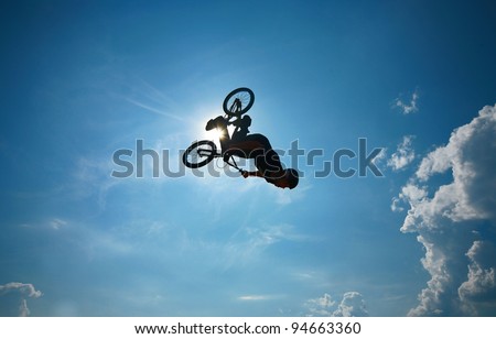 BMX rider performing air trick "back-flip"