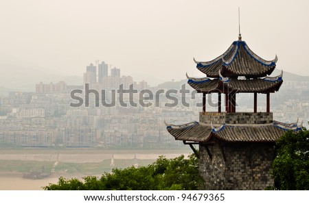 ancient chinese pagoda overlooking yangtze river against a modern skyline Royalty-Free Stock Photo #94679365