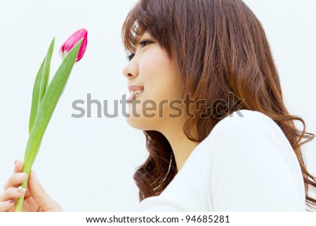 Beautiful young woman with tulip