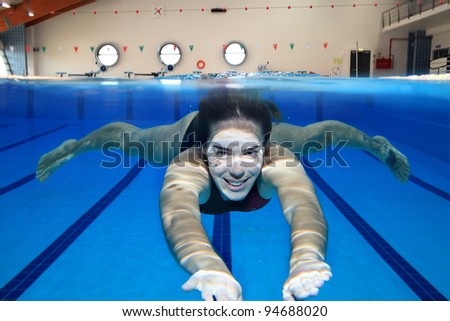 Underwater picture of a young woman swimming.