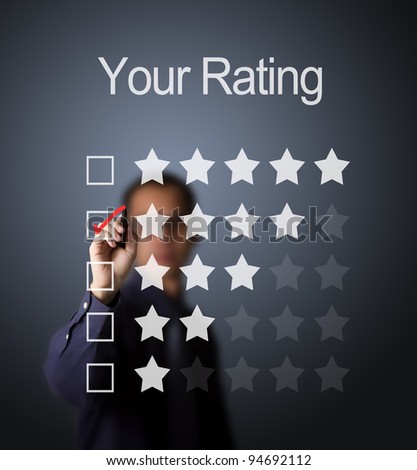 business man writing red mark on four star choice on rating survey form