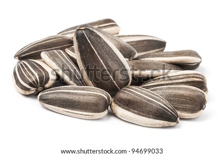 sunflower seeds pile against white background Royalty-Free Stock Photo #94699033