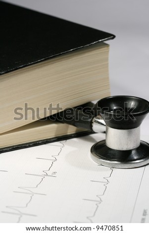 Book and stethoscope on a EKG printout