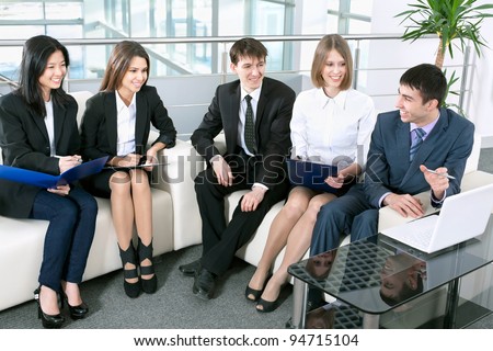 Group of business people analyzing and discussing during a working meeting in a modern office