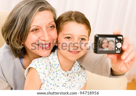 Grandmother and granddaughter take picture themselves smiling close-up portrait