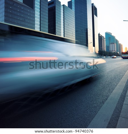 car motion blur at modern city street in dusk