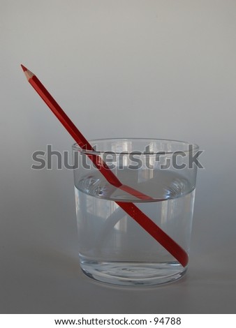 Red pencil in a glass of water, depicting refraction, illusion. Royalty-Free Stock Photo #94788