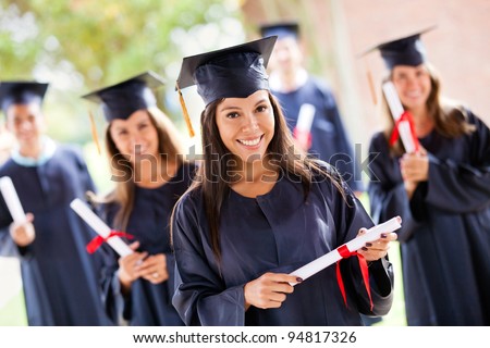 Group of people in their graduation day wearing a gown and mortarboard Royalty-Free Stock Photo #94817326