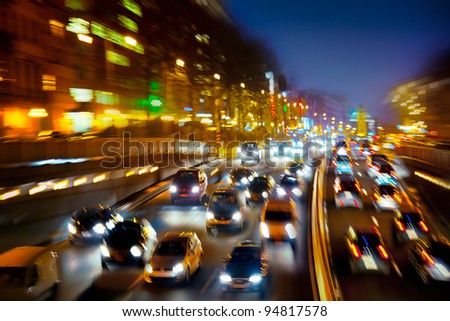 Car traffic at night. Motion blurr?d. Background. Royalty-Free Stock Photo #94817578