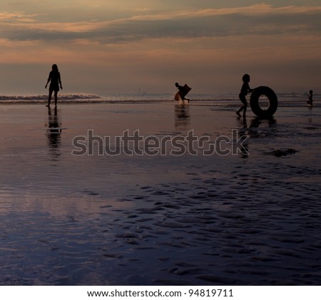 silhouette of people  in activities on the sea beach