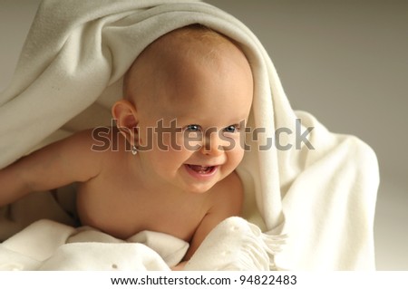 Picture of one happy child with white blanket