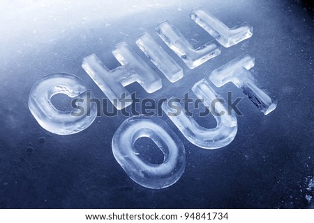 Words "Chill Out" made of real ice letters on ice background.