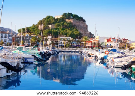 Denia mediterranean port village with castle mountain and blue sea water Royalty-Free Stock Photo #94869226