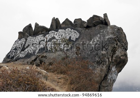 Ancient stone carved with the buddhist mantras over Namche Bazsar - Nepal, Himalayas