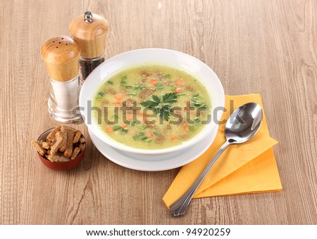 Tasty soup on wooden background