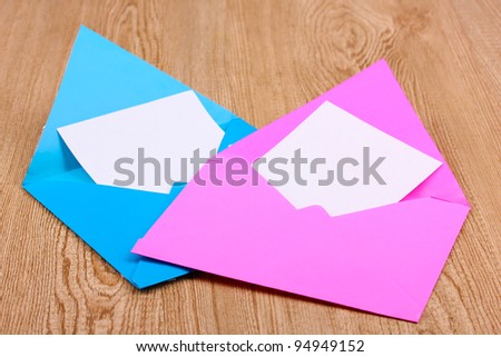 Color envelopes on wooden background