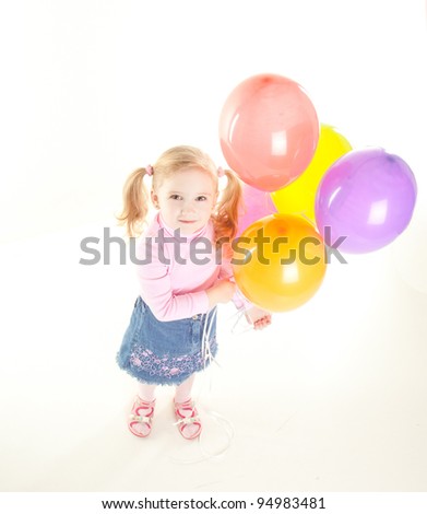 studio shot of pretty  little girl with balloons