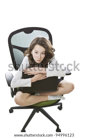 Asian Preteen girl sitting in computer chair with laptop in lap on white background