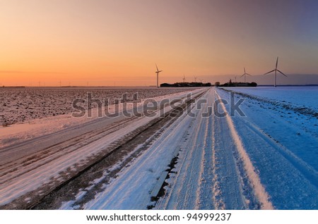 Wintry country road at sunset