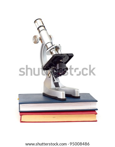 Microscope, books isolated on white