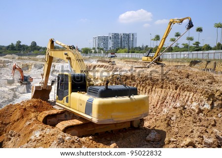 Heavy excavator loader at soil moving works in construction site. Royalty-Free Stock Photo #95022832