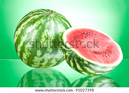 Watermelon and half on a green background