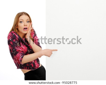young happy smile woman peeking over edge of blank empty paper billboard with copy space for text, isolated over white background
