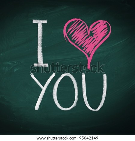 I Love You. Handwritten message on a chalkboard with an illustrated heart used as a symbol of love in this Valentines message.