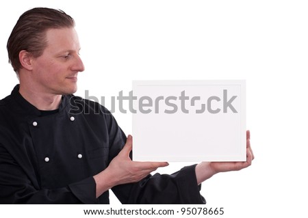 Cook is holding a white blank picture frame in his hands