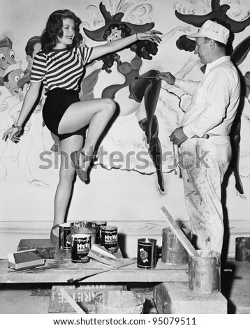 Dancing woman posing for mural painter